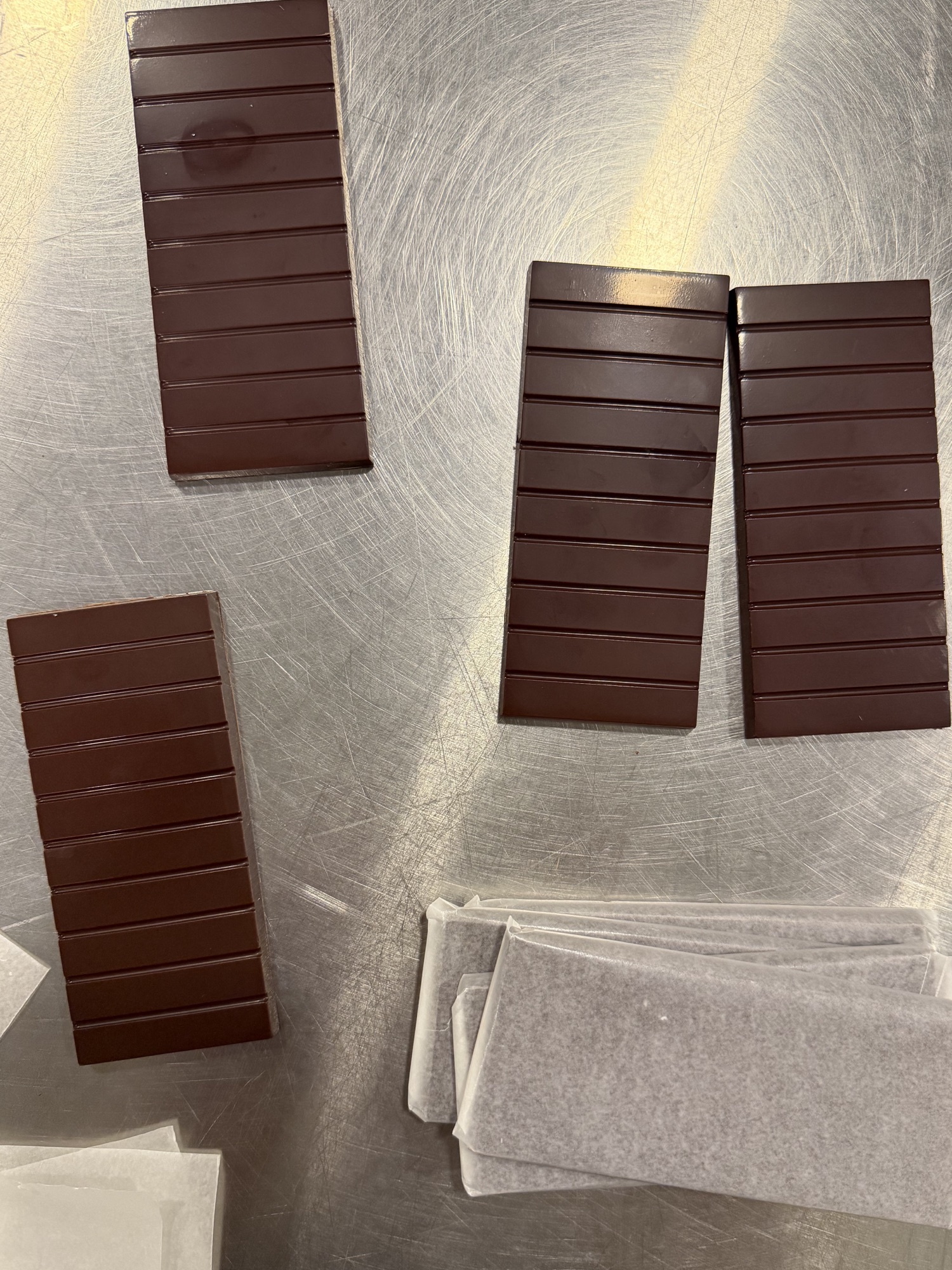 Four chocolate bars arranged during production