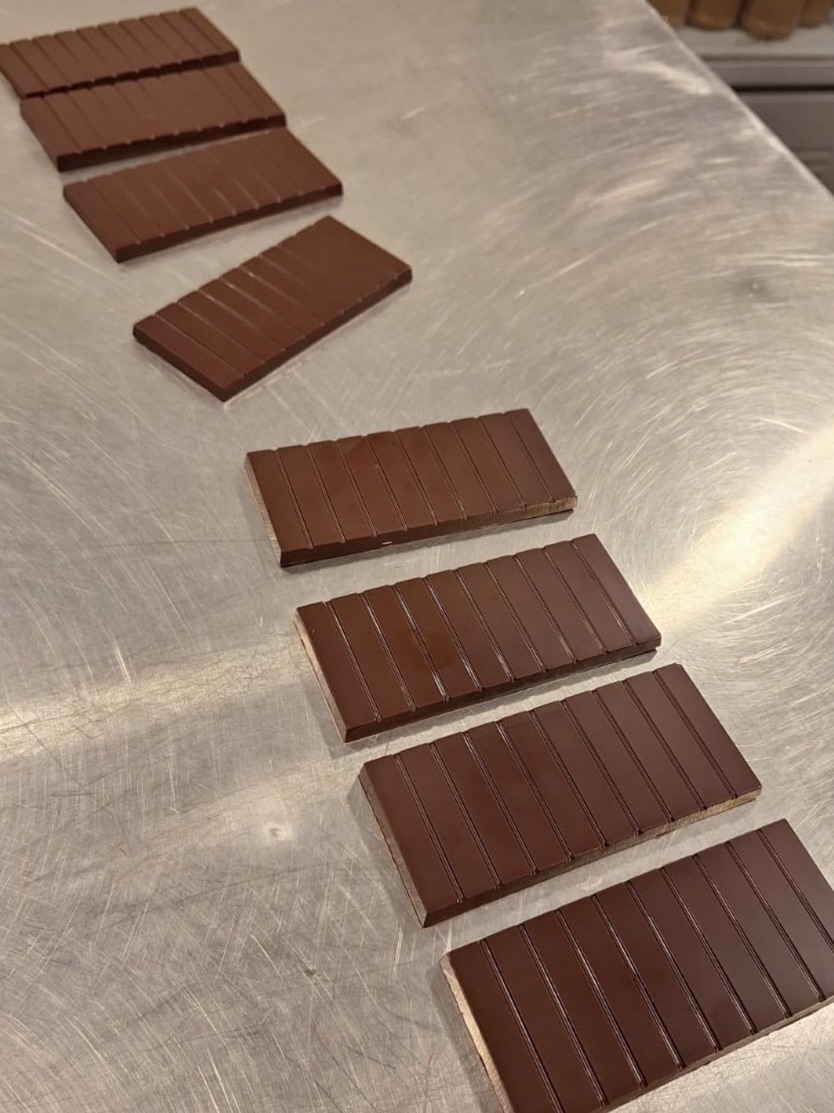 Finished chocolate bars arranged on a production table