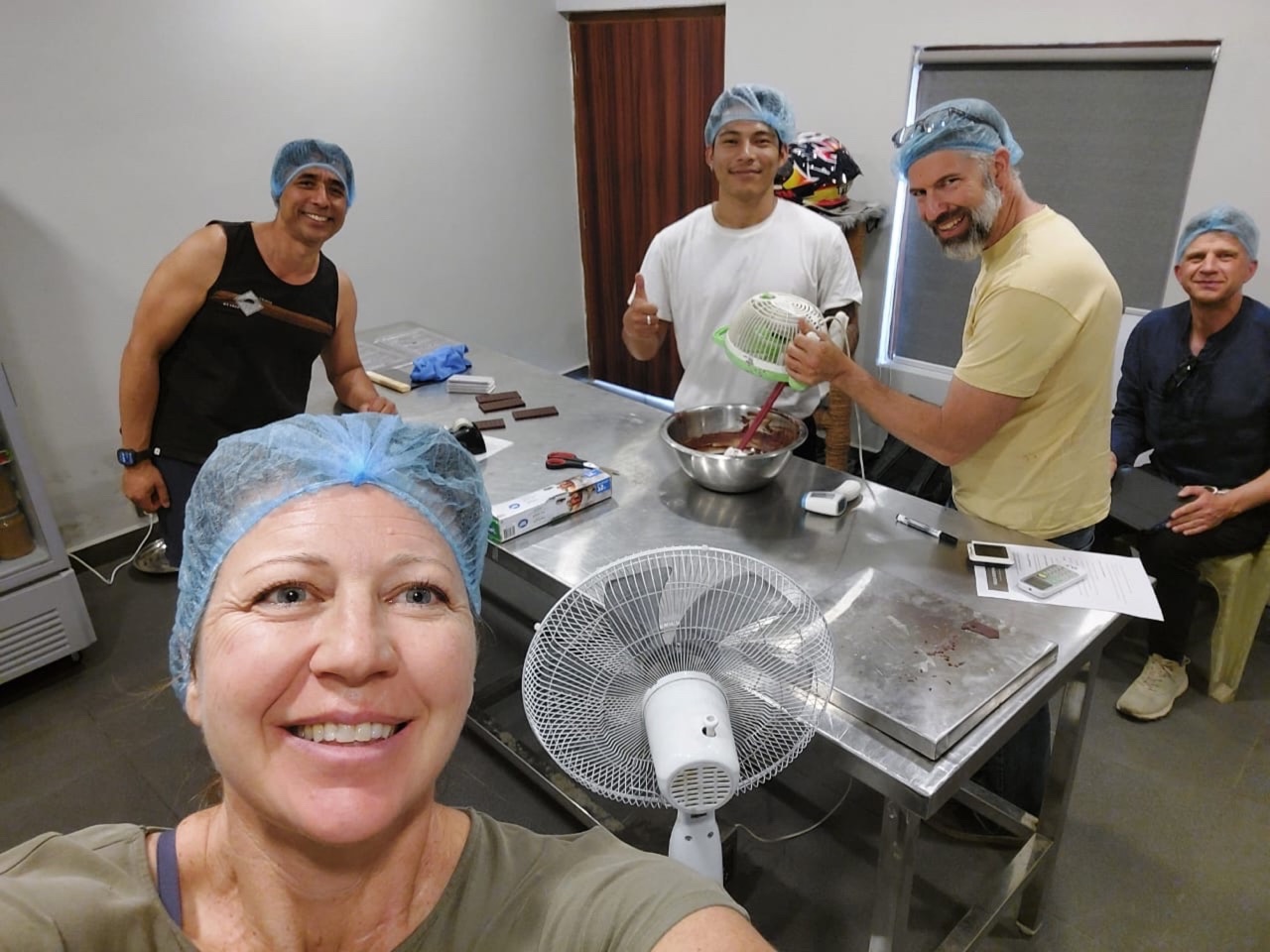 Chocolate makers working together in a small production lab