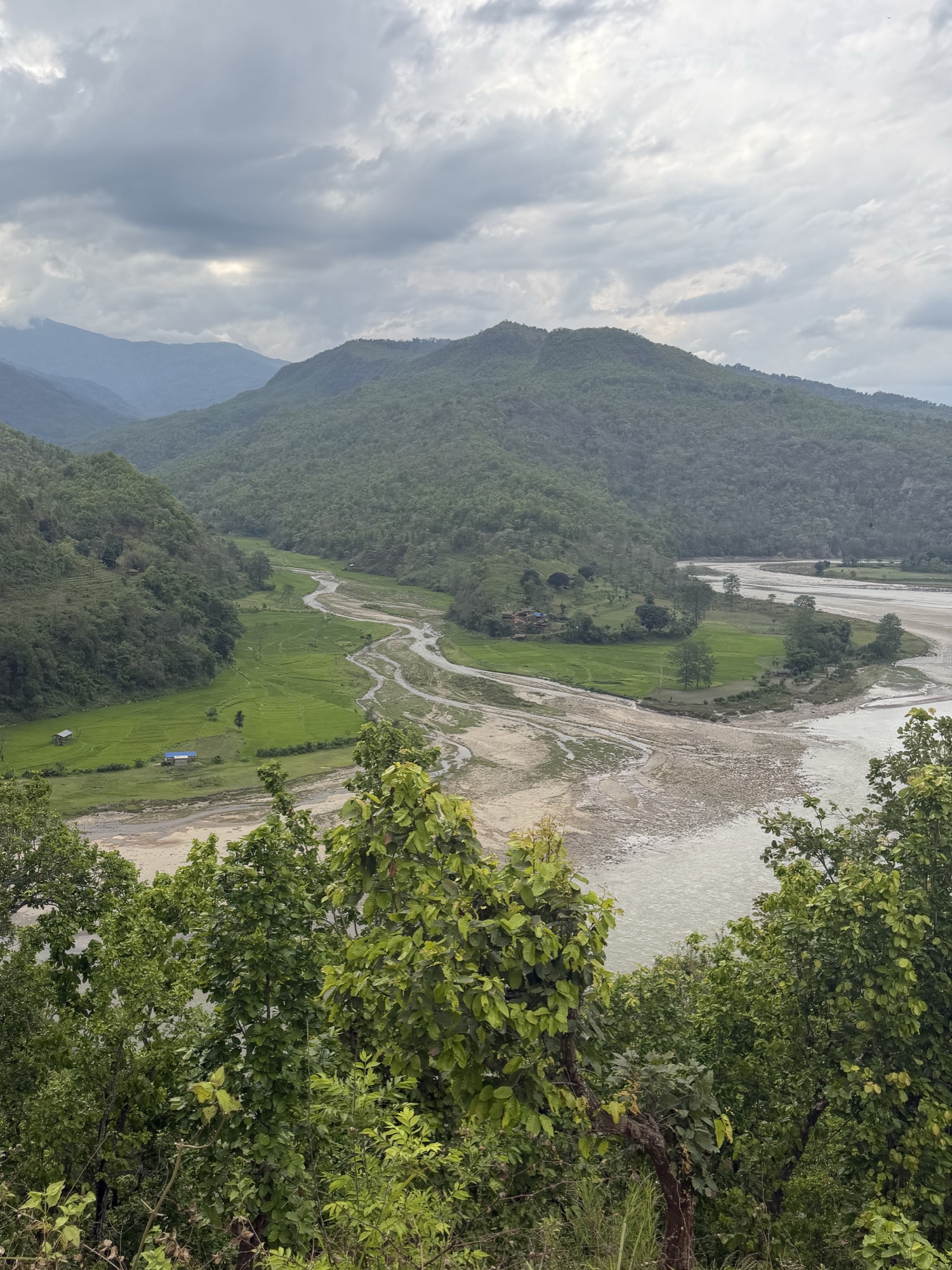 The Arun River winding through a green Himalayan valley in Nepal